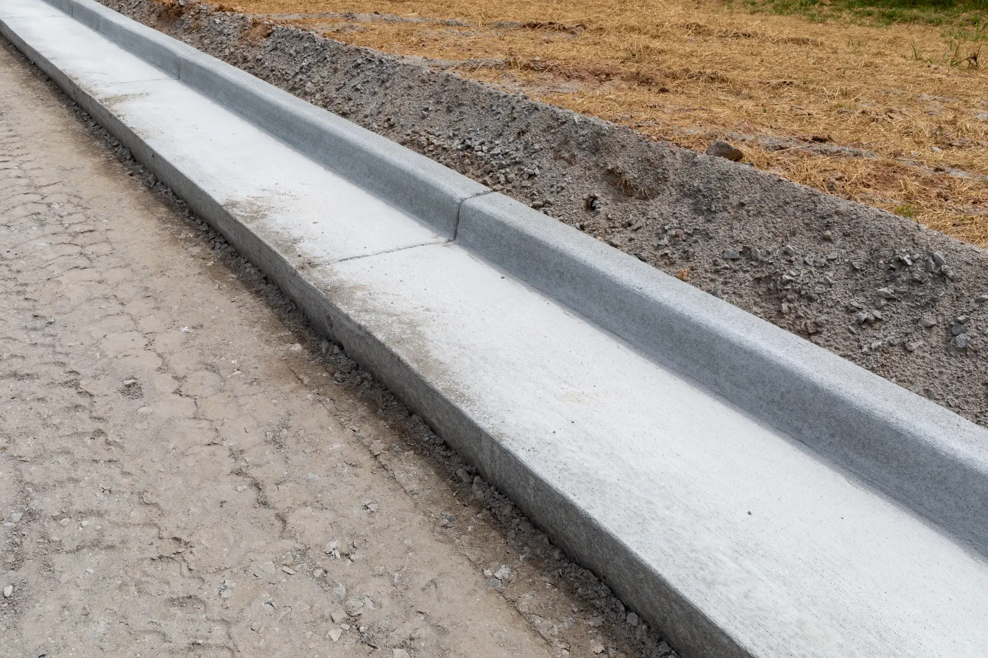 A close up view of a new machine curb prior to paving